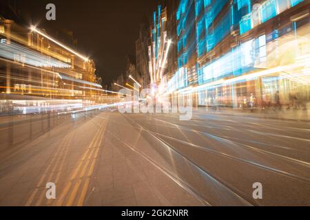 Amsterdam-Netherlands - August 21 2017; Retail street in city at night illuminated by building and traffic lights with department and clothing stores Stock Photo