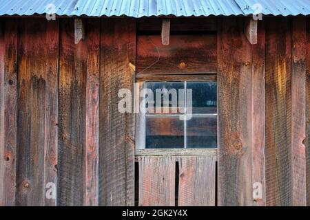 A window on the side of an old barn Stock Photo