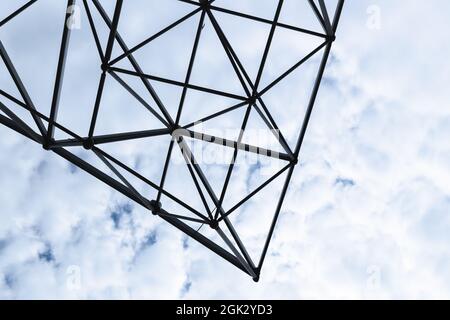 Abstract contemporary architecture details, girder structure of a roof, metal frame corner is under cloudy blue sky