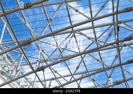 Abstract contemporary architecture background, structure of a glass roof with metal frame