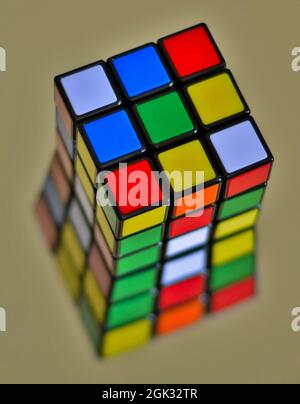 Rubik's Cube puzzle on a mirror creating an abstract reflection. Stock Photo