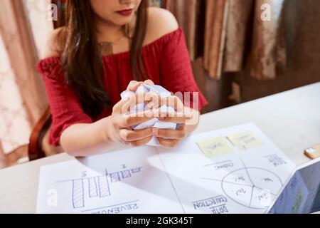 Hands of frustrated businesswoman crumpling paper after finding big mistake in report Stock Photo
