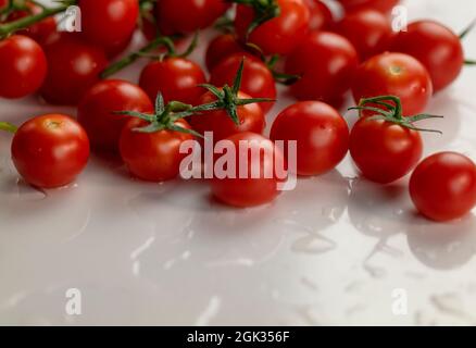 Group of cherry tomatoes on white table Stock Photo