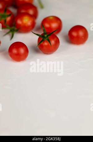 Group of cherry tomatoes on white table Stock Photo