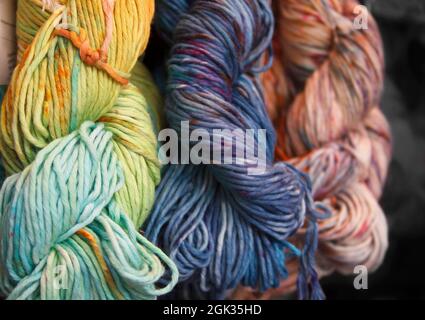 Diversified cotton yarn for knitting. Hand-dyed threads. Modern tie dye. Craft and hobby. Multicolored background Stock Photo