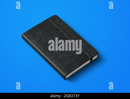 black closed notebook mockup isolated on blue Stock Photo