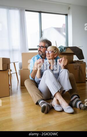 Portrait of happy senior couple in love moving in new home Stock Photo