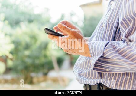hands of a senir man using a smart phone. seniors and technology Stock Photo