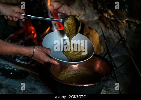 In Cerentino, visitors can stay in the lavishly renovated historic patrician house Cà Vegia, with centuries-old original furnishings but without electricity. Polenta is prepared over the open fire, Circolo della Rovana, Switzerland Stock Photo