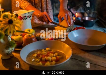 In Cerentino, visitors can stay in the lavishly renovated historic patrician house Cà Vegia, with centuries-old original furnishings but without electricity. Polenta is prepared over the open fire, Circolo della Rovana, Switzerland Stock Photo