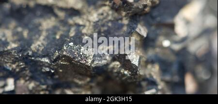 Iron ore nugget texture. Dark crystal background. Banner format Stock Photo