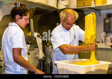 Panettone Prduction in the Pasticceria Marnin in Locarno, Switzerland. Circolo di Locarno, Switzerland. Arno Antognini with his daughter Naomi. Here, part of the pre-dough is weighed out. Because in the next step the main dough is enriched with different ingredients