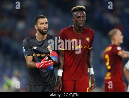 Rome, Italy. 12th Sep, 2021. Rui Patricio, goalkeeper of AS Roma, left, and his teammate Tammy Abraham in action during the Serie A soccer match between Roma and Sassuolo at the Olympic Stadium. Roma won 2-1. Credit: Stefano Massimo/Alamy Live News Stock Photo