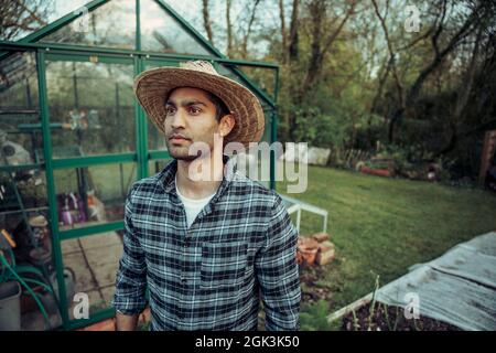Mixed race male farmer working outdoors on fresh farmland Stock Photo