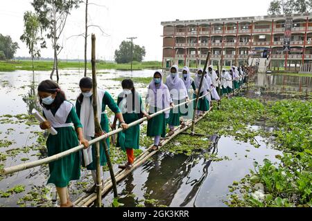 Students Coming Out From The School Walking On The Bamboo Bridge As The School Area Affected By Flood Waterafter Several Months All Schools And Colleges In The Country Begin Reopen On September