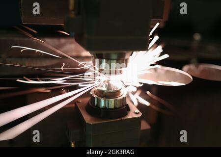 Laser cutting of metal sheet with sparks closeup Stock Photo