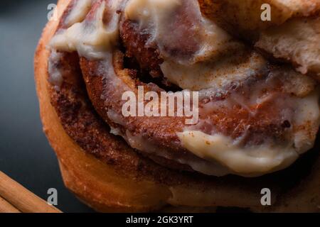 Close up of cinnamon roll on black background. Stock Photo