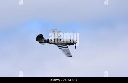 Vintage Yakovlev Yak-50 aircraft in flight bue sky and clouds. Stock Photo