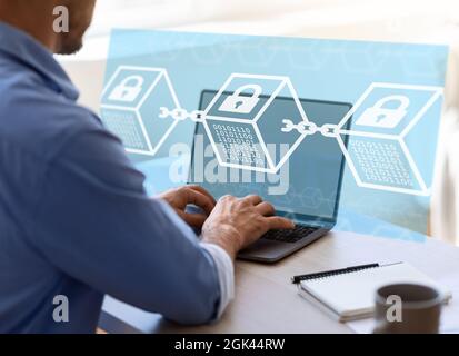 European young businessman working on computer, double exposure with abstract blocks and locks, digital hologram Stock Photo