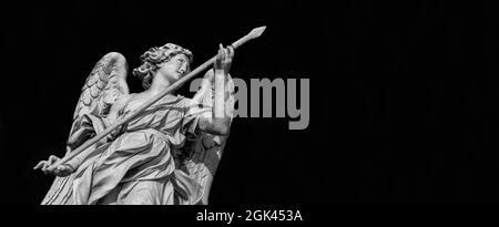 Angel statue holding the Holy Lance of Longinus. A 17th century baroque masterpiece at the top of Sant'Angelo Bridge in the center of Rome (Black and Stock Photo