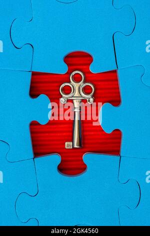 Find key to success, business opportunity or solution. Jigsaw puzzle with small metal key. Stock Photo