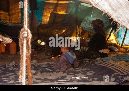 Locals and tent in the Moroccan Sahara Stock Photo