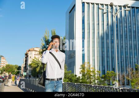 young african american business man talking on the phone walking in the city Stock Photo
