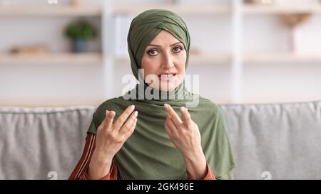 Headshot Of Middle-Aged Muslim Lady Talking Communicating Online Indoor, Panorama Stock Photo