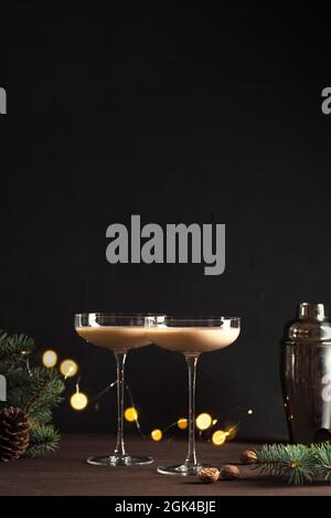 Christmas Brandy Alexander Cocktail on wooden table with Christmas decor. Festive cocktail drink. Stock Photo