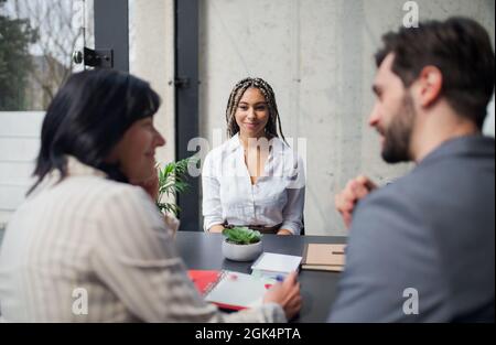 Happy young woman having job interview in office, business and career concept. Stock Photo