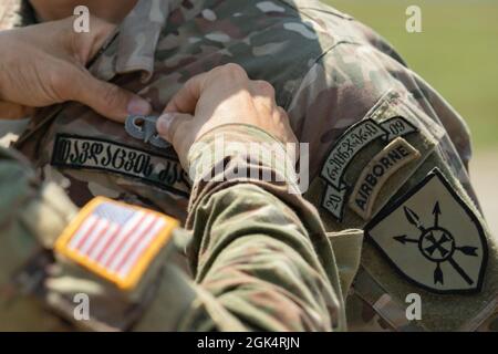 U.S. Army Lt. Col. Ari Martyn, commander, Headquarters, 1st Squadron, 91st Cavalry Regiment, 173rd Airborne Brigade, pins airborne wings on a Georgian Defense Force soldier during Agile Spirit 2021 at Vaziani Training Area, Georgia, July 27, 2021. Agile Spirit 2021 is a joint, multinational exercise co-led by the Georgian Defense Forces and U.S. Army Europe and Africa. Occurring July 26 through August 6, 2021, the brigade-level exercise incorporates a simulated command post exercise, field training exercise and joint multinational battalion level combined arms live-fires. Agile Spirit enhances Stock Photo