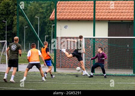 Croatia Land Forces soldiers from Storm Battery play football (soccer) during sports day at Bemowo Piskie Training Area, Poland, August 4, 2021. Battle Group Poland celebrated Croatian Day of Victory and Homeland Gratitude and also joined Croatians in celebrating the Day of Croatian War Veterans at Bemowo Piskie Training Area, August 4-5, 2021. US, UK and Romanian soldiers joined Croatians for a football, volleyball and bocce tournament building the battle group’s unity and partnership. Stock Photo