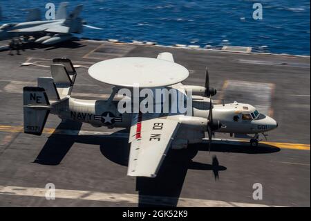 210803-N-RO680-1053 PACIFIC OCEAN (August 3, 2021) An E-2D Advanced Hawkeye, assigned to the “Black Eagles” of Carrier Airborne Early Warning Squadron (VAW) 113, performs a touch-and-go during flight operations on the flight deck of Nimitz-class aircraft carrier USS Carl Vinson (CVN 70), August 3, 2021. The Carl Vinson Carrier Strike Group (CVCSG), led by Carrier Strike Group (CSG) 1, is deployed in support of global maritime security operations. Stock Photo