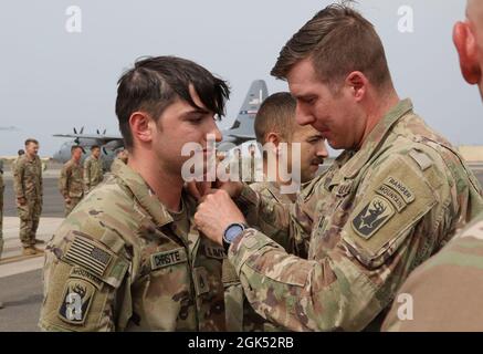 Staff Sgt. Dennis Christe, assigned to Apache Company, 1-102nd Infantry Regiment (Mountain), earns the Army Achievement Medal for developing a training course on Military Operation in Urban Terrain (MOUT) for the company during mobilization, at Camp Lemonnier, Djibouti, Aug. 3, 2021. Stock Photo