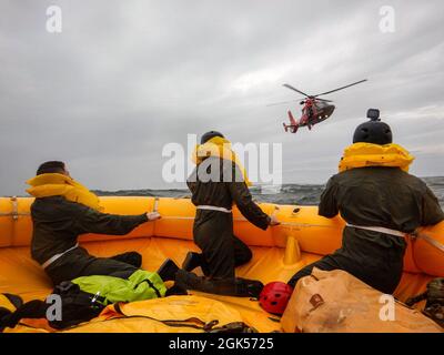 Airmen from the 436th Operational Support Squadron survival, evasion, resistance and escape flight sit in a 25-man survival raft near Coast Guard Station Indian River Inlet, Delaware, Aug. 4, 2021. Exercise Castaway is an interagency training exercise that brought Airmen from Dover AFB and two coast guard stations, Coast Guard Air Station Atlantic City, New Jersey, and Coast Guard Station Indian River Inlet, Delaware, together to train local search and rescue procedures. Stock Photo