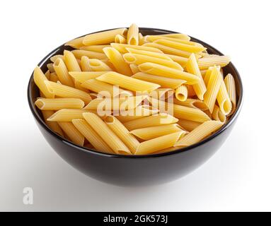 Uncooked penne pasta in black bowl isolated on white background with clipping path Stock Photo