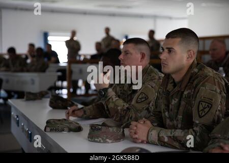 U.S. Army Sgt. Brent Grafmuller (right), Andover, Massachusetts native, and Military Police Assistant Squad Leader with 18th Military Police Brigade, 21st Theater Sustainment Command, attends an icebreaker event during the U.S. Army Europe and Africa Best Warrior Competition at U.S. Army Garrison Hohenfels Training Area, Germany, Aug. 6. Soldiers from across U.S. Army Europe and Africa compete for the title of ‘Best Warrior’ August 6-12 at Hohenfels and Grafenwöhr training areas. Stock Photo