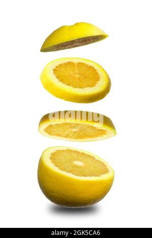 Sliced flying orange grapefruit isolated on white background. Cut orange grapefruit in pieces. Levity fruit floating in the air. Flying food concept. Stock Photo