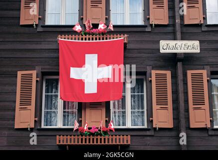Swiss hanging in front of a typical wooden chalet in Murren, Switzerland Stock Photo
