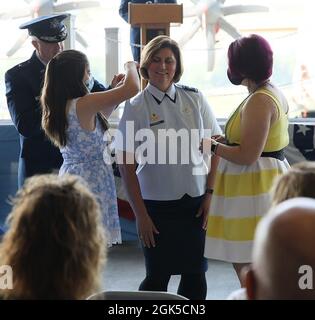 New York Air National Guard Brig. Gen. Michelle Kilgore's daughters, Abbey and Erica, place her new general's rank on her uniform blouse, as Kilgore's husband, Brig. Gen. Robert Kilgore, left, looks on during promotion ceremonies held on Friday, August 6, 2021 at Stratton Air National Guard Base in Scotia, New York. Kilgore, who now serves on the staff of the Joint Chiefs of Staff at the Pentagon, is a former fighter piloted who commanded the 109th Airlift Wing, which is based at Stratton Air National Guard Base. Stock Photo