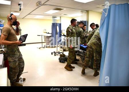 Medics work on an operative experience manikin at the Joint Readiness Training Center Rear Aid Station as Sgt. Jonathan Harris, 3rd Battalion, 353rd Regiment, monitors and controls the manikin’s vital signs. Stock Photo