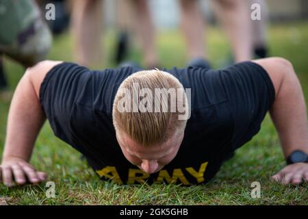 Soldiers of the Maryland National Guard’s 291st Digital Liaison Detachment, 110th Information Operations Battalion and 169th Cyber Protection Team conduct the Hand Release Push-up, one of the six events in the Army Combat Fitness Test on Fort George G. Meade, Maryland, August 7, 2021. The ACFT is intended to improve Soldier physical readiness, transform the culture of Army fitness, reduce preventable injuries and attrition, enhance mental strength and stamina, and contribute to increased unit readiness. Stock Photo