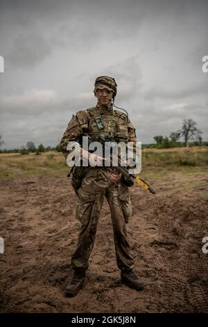 British Army 2nd Lt. Lucas Handyside, a member 1st Battalion, 4th Parachute Regiment, poses for a portrait at Camp Grayling Joint Maneuver Training Center, Michigan, Aug. 8, 2021, during Northern Strike.    Northern Strike is an opportunity to build interoperability with other units and multinational partners while training in realistic multi-domain environments. Stock Photo