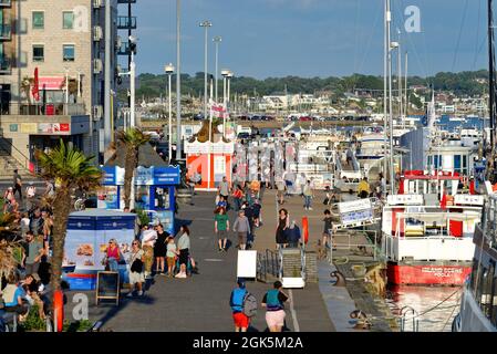 A busy waterfront on Poole Quay on a summers evening, Dorset England UK Stock Photo