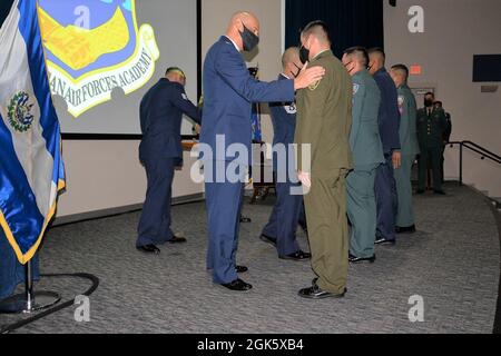 Col. Jose Jimenez, Inter-American Air Forces Academy commandant, congratulates a member of Class 2021-B at the graduation ceremony Aug. 10, 2021, at Joint Base San Antonio-Lackland, Texas. Class 2021-B was the largest in-person class to graduate from IAAFA since COVID struck approximately 17 months ago. The class of 134 included 121 International Military Students from nine countries and 13 U.S. military members – 89 enlisted and 45 officers. Stock Photo