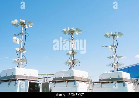 Three powerful mobile antennas on the roofs of a van car for communication or location observation in the immediate radius of the space, mobile point Stock Photo