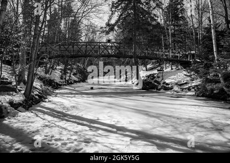 black and white photo of a pedestrian bridge spanning of the shubenacadie canal Stock Photo