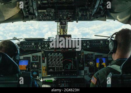 U.S. Air Force Maj. Jay Heide, left, and Capt. Nate Armes, 906th Air Refueling Squadron, pilot a KC-135 Stratotanker over the Republic of Poland during the 126th Air Refueling Wing's, Illinois Air National Guard, Aviation Detachment Rotation 21-3, in Powidz, Republic of Poland on Aug. 11, 2021. Participation in training events like Aviation Detachment Rotation enhances professional relationships and improves overall coordination with allies and partner militaries during times of crisis. Stock Photo