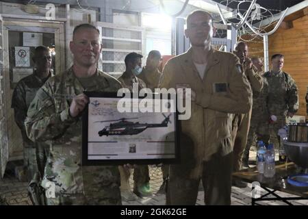 Task Force Phoenix commander Col. Alan Gronewold is presented a gift by Task Force Griffon outgoing commander Lt. Col. Francesco Colucei after a Transfer of Authority ceremony at Erbil Air Base, Iraq. Task Force Griffon, from the 5th Regiment of the Italian Army, is a detachment of three NH-90 medium lift helicopters, aircrew and support personnel based at Erbil Air Base, Iraq, under tactical control (TACON) of Task Force Phoenix. Lt. Col. Francesco Colucei turned over the unit to Lt. Col. Mario Giorgi. Stock Photo