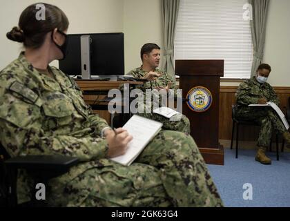 KADENA, Japan (Aug. 12, 2021) Senior Chief Electronics Technician Brian Kelley, Commander, Fleet Activities Okinawa command climate specialist, leads a discussion during a regular navy ball committee meetings at CFAO headquarters on Kadena Air Base, Okinawa, Japan. CFAO maintains and operates facilities to support the US Navy’s naval and aviation assets in the Indo-Pacific region. Stock Photo